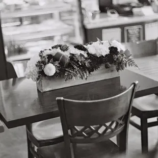 a flower arrangement in a wooden box