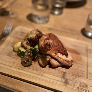 a plate of food on a wooden cutting board