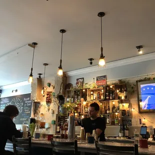 a bar with people sitting at the bar