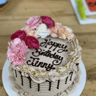 a birthday cake with flowers on top