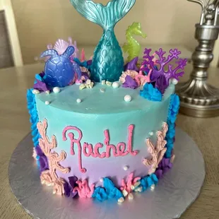 My daughter's adorable mermaid-themed birthday cake. Chocolate and vanilla marble cake with whipped cream frosting. Delicious!! ‍