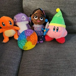I won the Charmander, Stitch, and Kirby. The little girl and the pop it were free gifts
