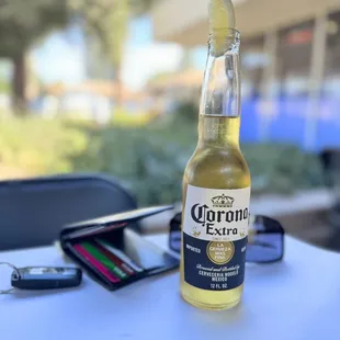 a bottle of corona extra beer on a table