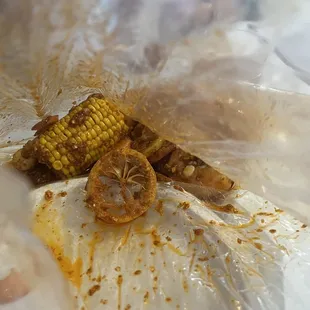 Boiled in bag shrimp w shambalang sauce and a corn cob
