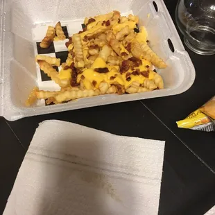 a tray of fries and a bag of chips