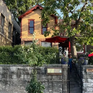 a yellow house with red trim