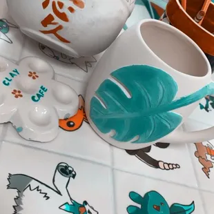 Painting in progress.  Chopstick bowl and monstera mug.