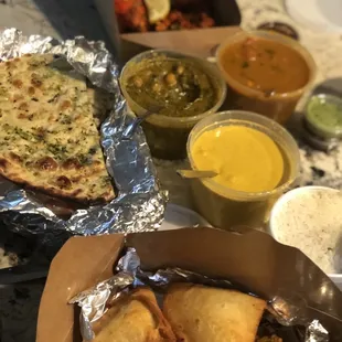 Tandoori Chicken, garlic Naan, Saag paneer, chicken curry, coconut chicken curry and samosas
