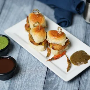 a plate of sandwiches with dipping sauce