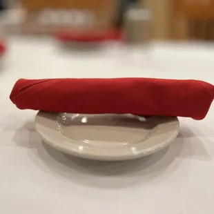 a red napkin on a white plate