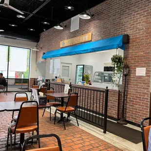 the interior of a restaurant with tables and chairs