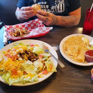 Taco salad, cheese quesadilla, and shredded chicken sandwich