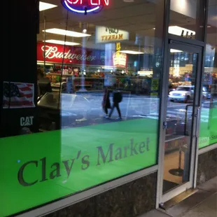 a storefront with a neon sign