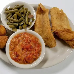Catfish fillets with hush puppies, green beans, and breaded tomatoes