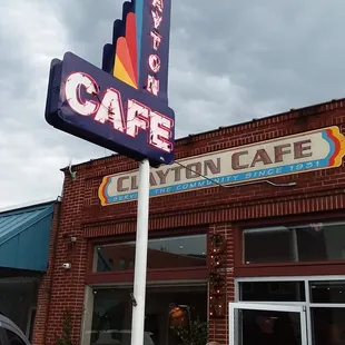 a woman standing in front of the restaurant