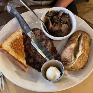 8oz ribeye, Texas toast, baked potato with butter on the side and added side of mushrooms.