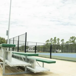 Bleachers offer great spectator comfort during tennis matches. The tennis area also has a covered pavilion and water fountain.