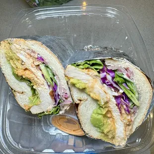 two halves of a sandwich in a plastic container