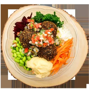 a plate of meatballs, vegetables, and mashed potatoes