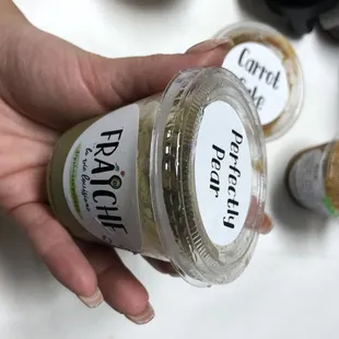 a hand holding a jar of food