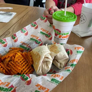 GOAT wrap w sweet potato fries and unsweetened Mango tea.