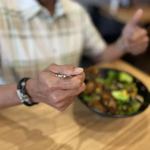 a man sitting at a table with a plate of food