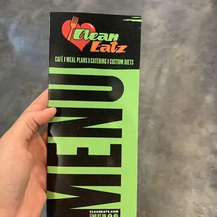 a hand holding a box of clean eatz