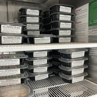 plastic containers on shelves in a refrigerator