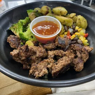 Build Your Own Bowl with Bison, Broccoli,  Corn &amp; Black Beans, Rosemary Potatoes and Sweet Chili Sauce.