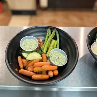 Kale and Quinoa vegetarian bowl - with asparagus, cucumbers, carrots, and corn and black bean.  Goddess sauce on the side.