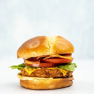 a hamburger with lettuce, tomato, and cheese