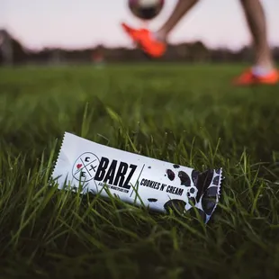 a bar on the grass with a soccer ball in the background
