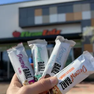 a hand holding six bars of clean eatz