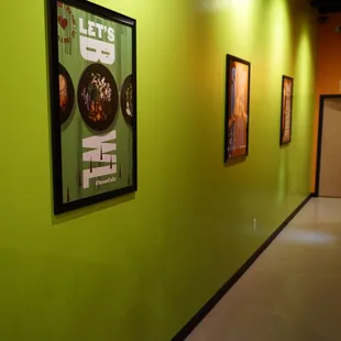 a hallway with framed posters