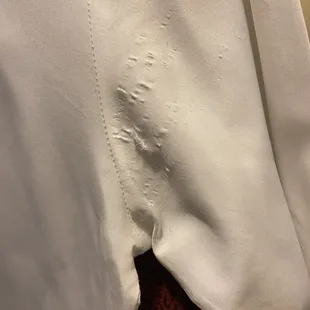 Arm pit area of a white bottom up dress shirt