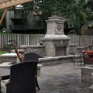a patio with an outdoor fireplace