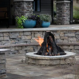 a fire pit in the middle of a patio