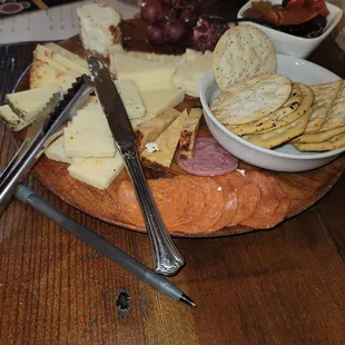 cheese, crackers, and crackers on a wooden platter