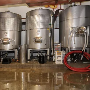 a row of stainless steel tanks