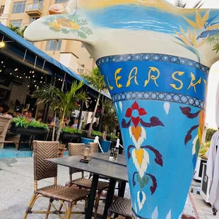 Gorgeous painted dolphin and sidewalk seating