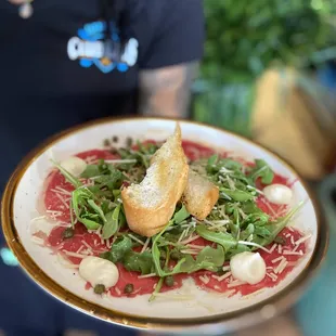 a person holding a plate of food