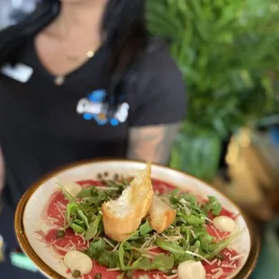 a woman holding a plate of food