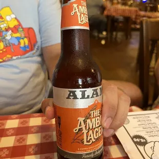 a person holding a bottle of ale