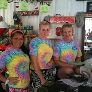 three women in tie dye shirts