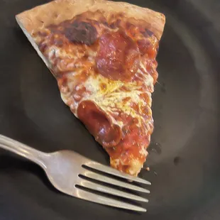 a slice of pizza on a plate with a fork