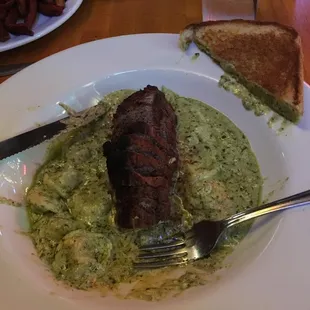 Blackened sirloin ordered to temp w cheese tortellini in pesto cream sauce