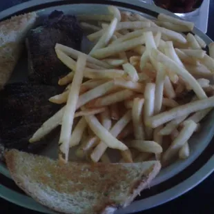 a plate of fries and steak