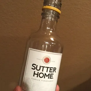 a hand holding a bottle of butter home