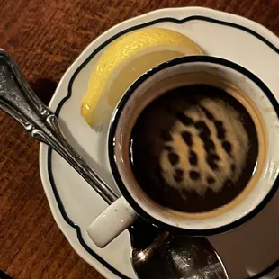 Double espresso with a wedge of lemon