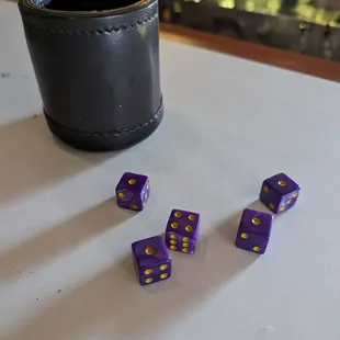 purple dice with yellow spots